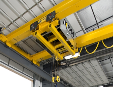 Warehouse crane hoisting heavy equipment