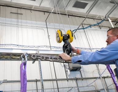 Worker ensuring safety protocols in a facility with R&M Materials Handling equipment